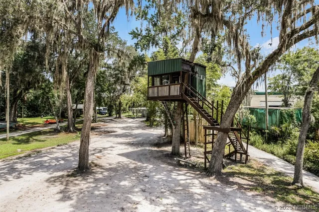 a view of a street with a tree