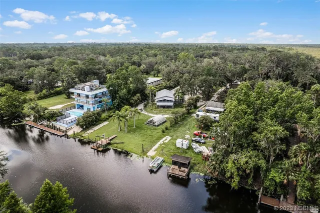 an aerial view of a house with a lake view