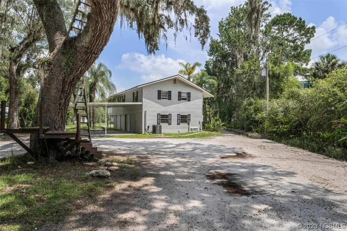 486 Detroit Terrace DeBary, FL 32713 - Photo 6 of 47 a front view of a house with a garden