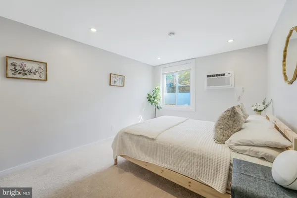 a bedroom with a bed and a couch