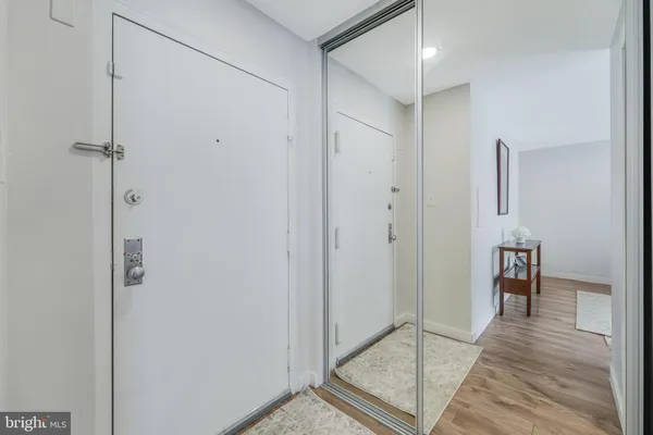 a view of a hallway with wooden floor