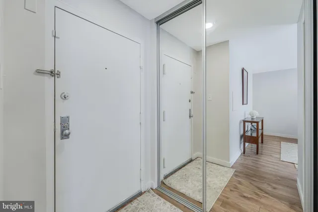 a view of a hallway with wooden floor