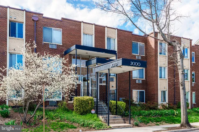 a view of a brick building next to a yard