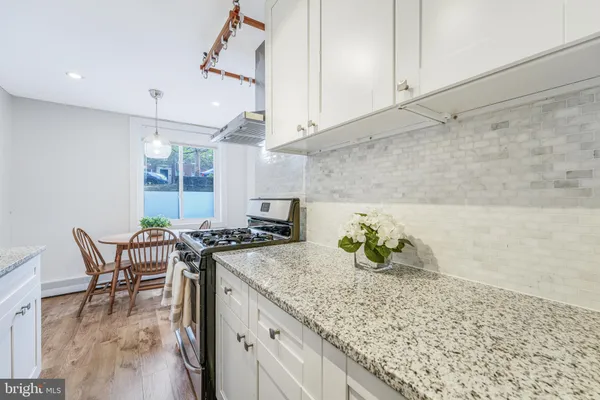 a kitchen with a table and chairs in it