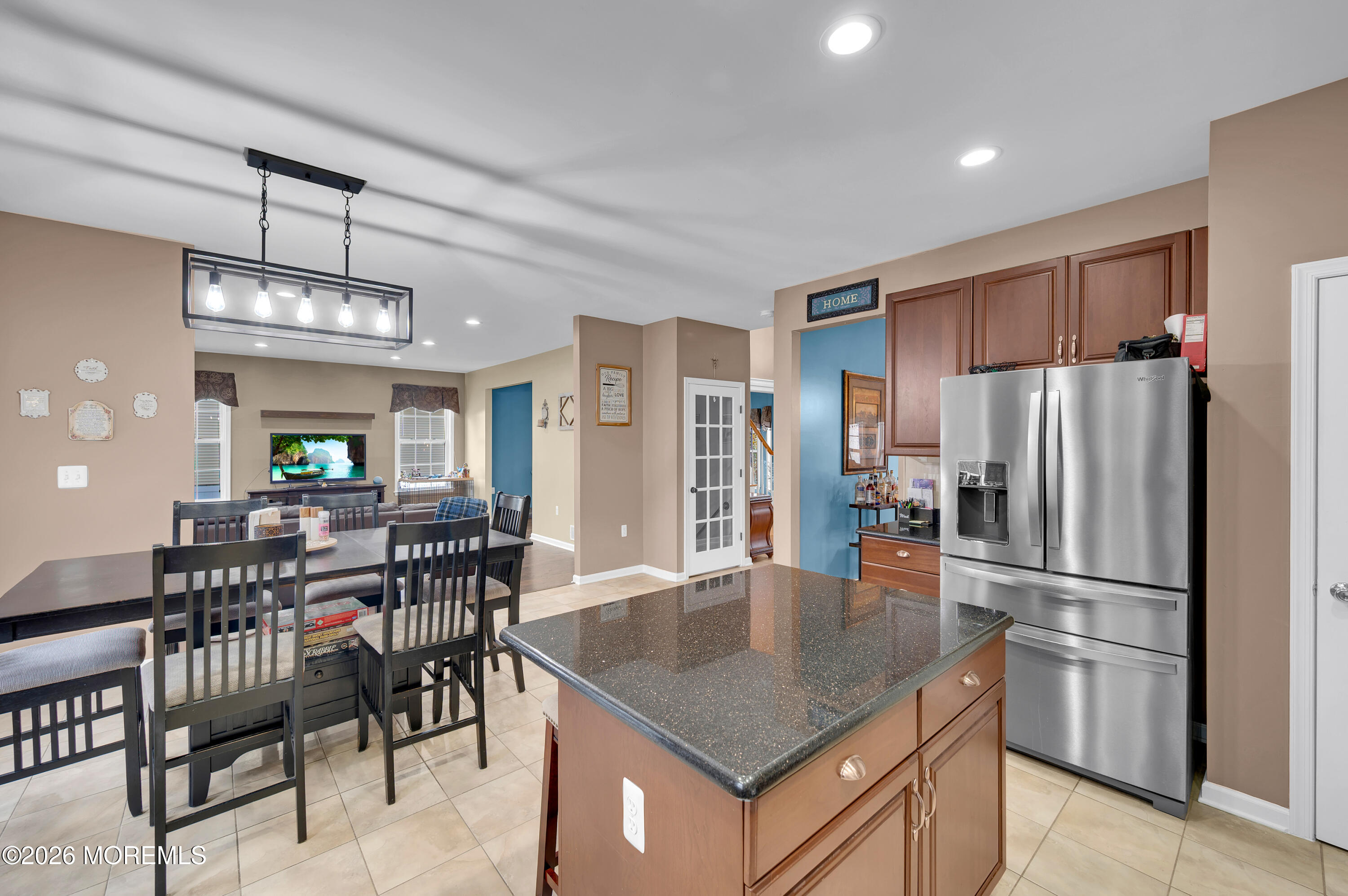 6 Reuben Court Howell, NJ 07731 - Photo 24 of 66 a kitchen with refrigerator a dining table and chairs