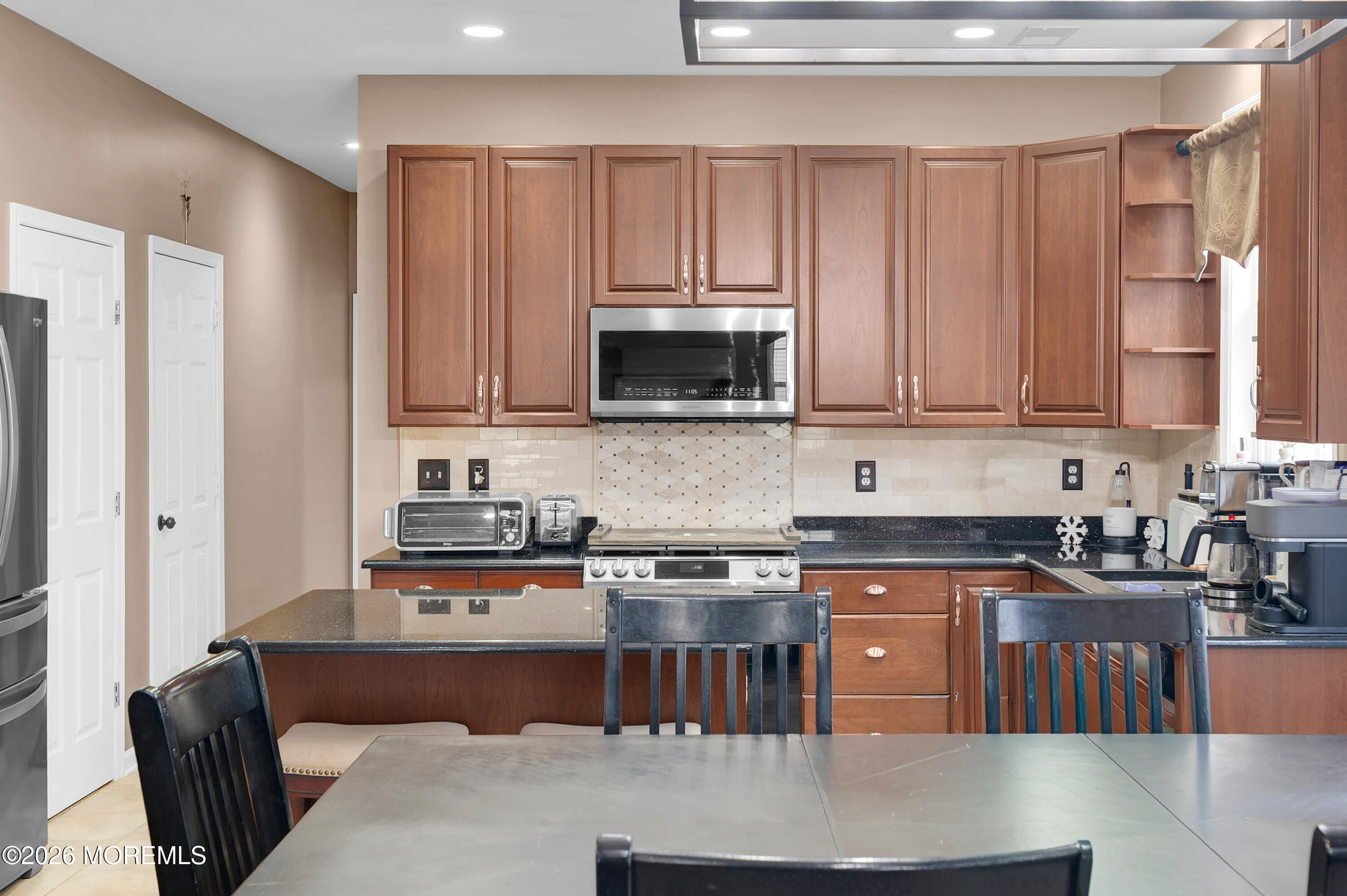 6 Reuben Court Howell, NJ 07731 - Photo 54 of 66 a kitchen with stainless steel appliances granite countertop a stove a sink a microwave a refrigerator and cabinets