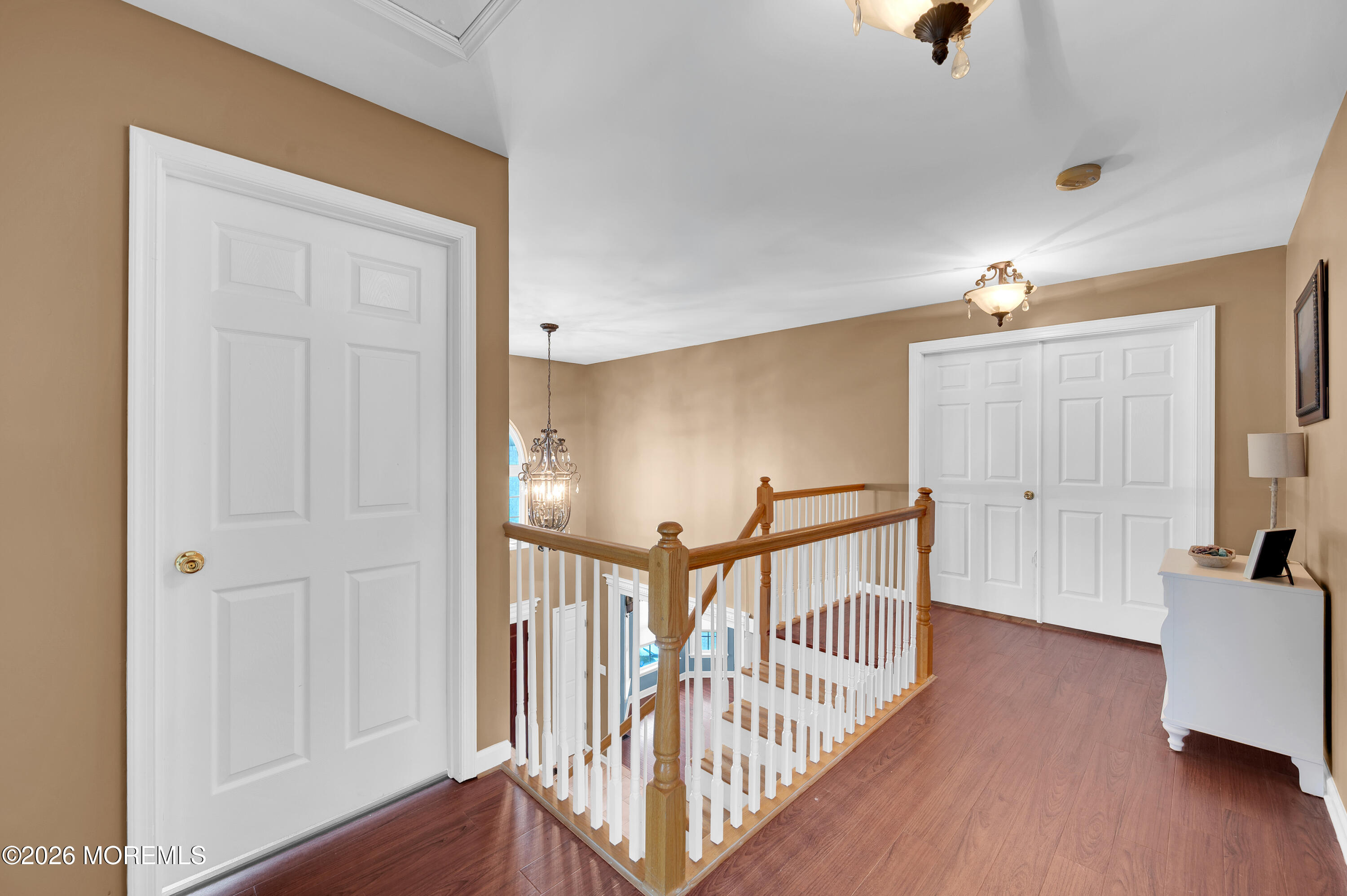 6 Reuben Court Howell, NJ 07731 - Photo 59 of 66 a view of a hallway with wooden floor and windows