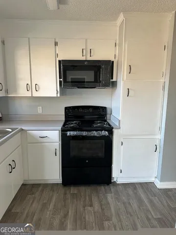 a kitchen with a stove and a microwave