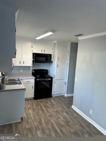 a kitchen with a sink and a stove top oven