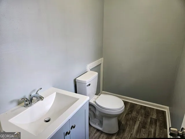 a white toilet sitting next to a bathroom sink