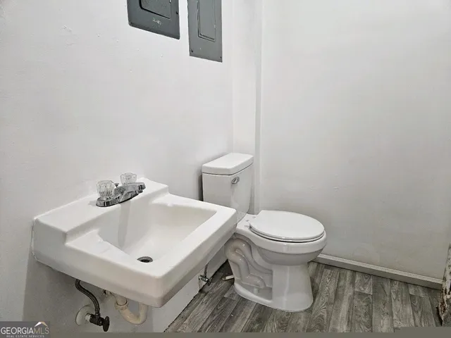 a white toilet sitting next to a white sink