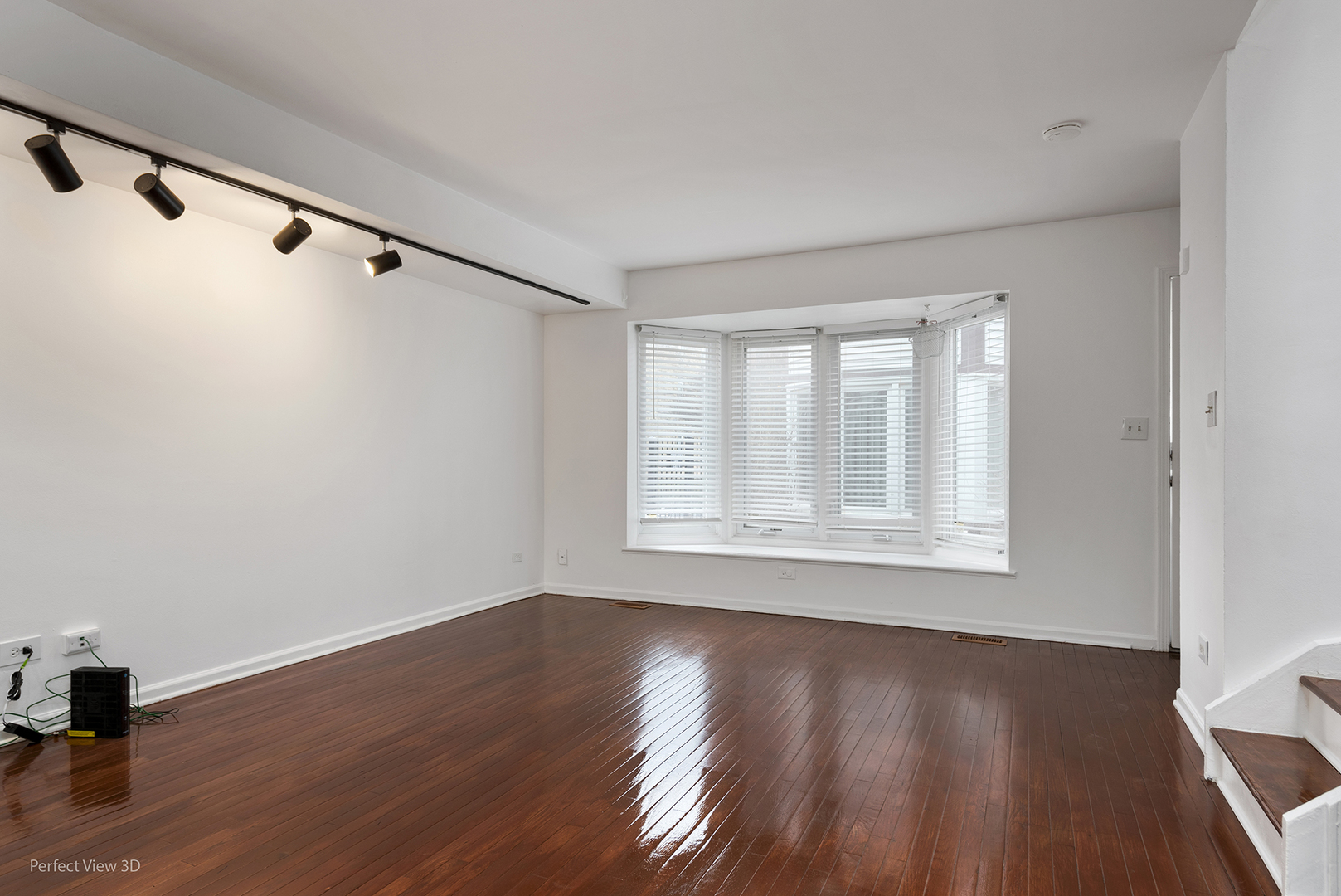 7539 North Ridge Boulevard, Unit 6 Chicago, IL 60645 - Photo 2 of 20 a view of an empty room with wooden floor and a window
