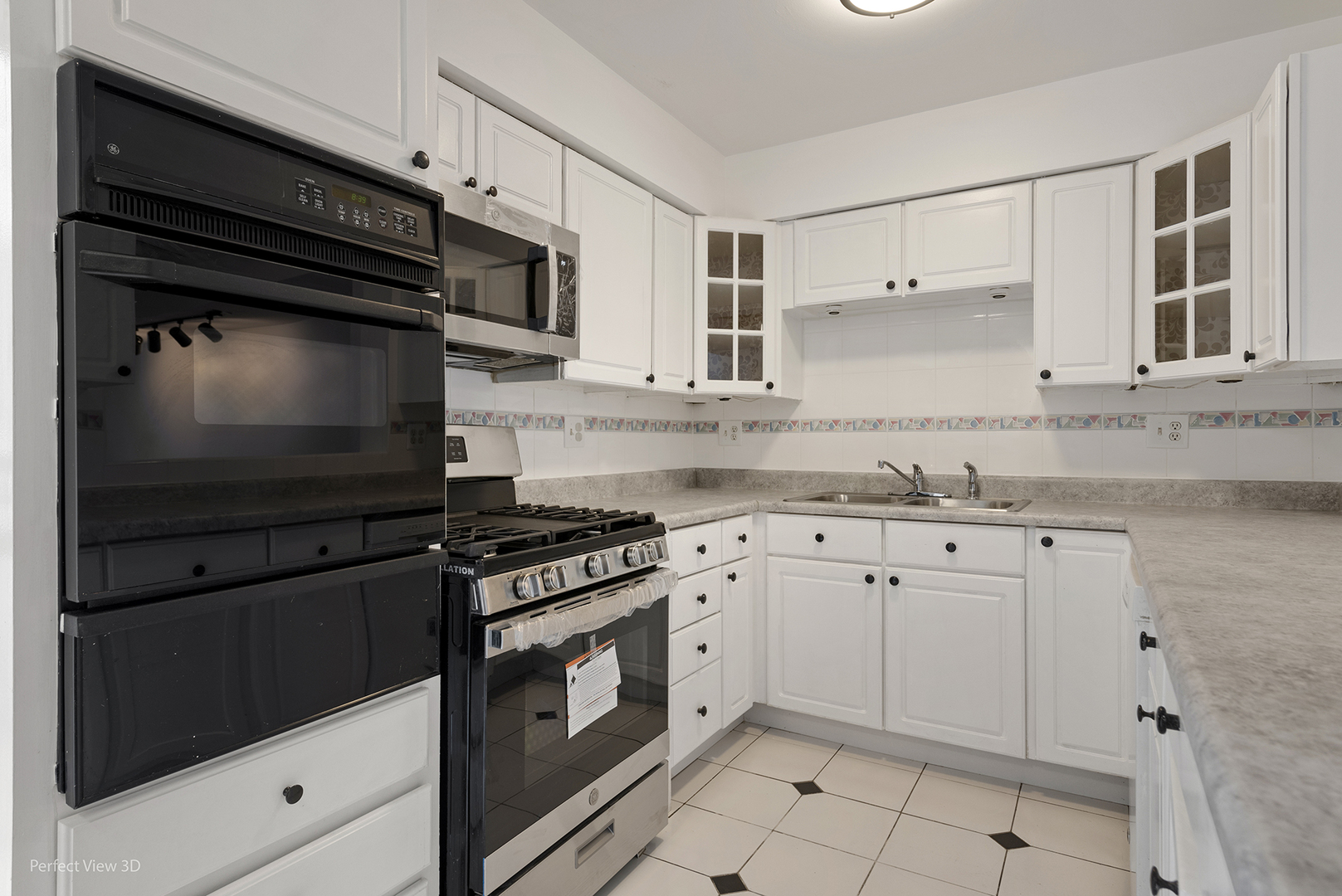 7539 North Ridge Boulevard, Unit 6 Chicago, IL 60645 - Photo 5 of 20 a kitchen with granite countertop cabinets and steel stainless steel appliances