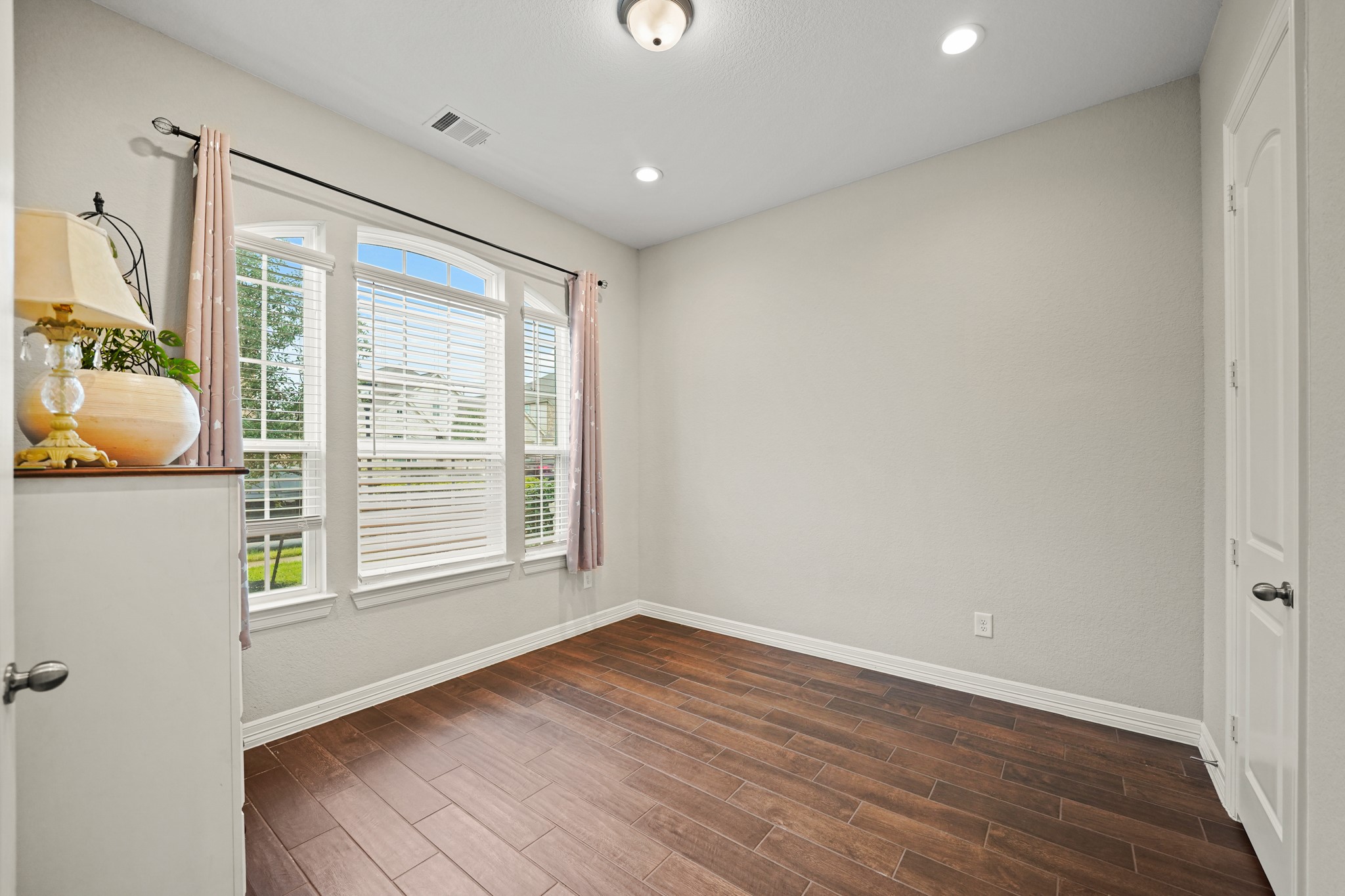 24031 Corinaldo Court Katy, TX 77493 - Photo 20 of 23 a view of an empty room with wooden floor and a window