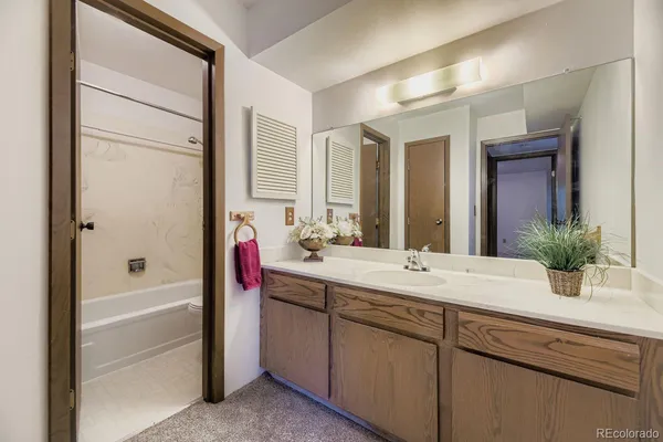 a bathroom with a shower a toilet and a sink