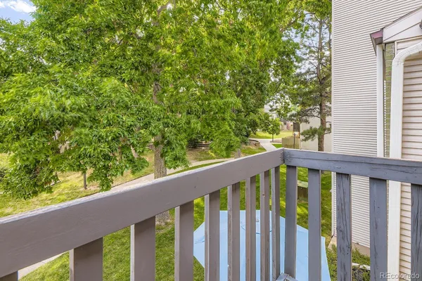 a view of a wooden deck with furniture