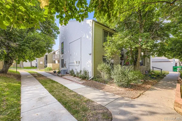 a pathway of a house with a yard