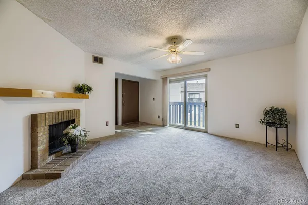 a view of empty room with a fireplace