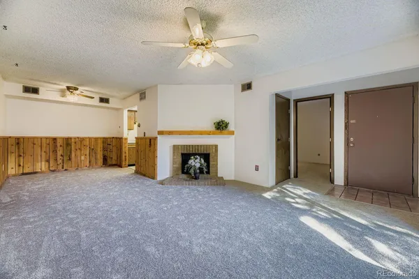 a view of an empty room with a fireplace
