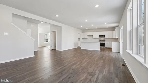 a kitchen with granite countertop a sink a stove and cabinets