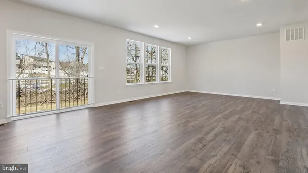 a kitchen with stainless steel appliances granite countertop white cabinets and a stove top oven
