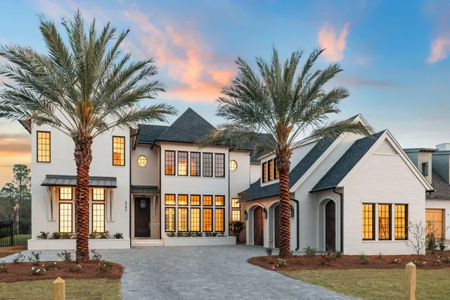a front view of a house with a garden