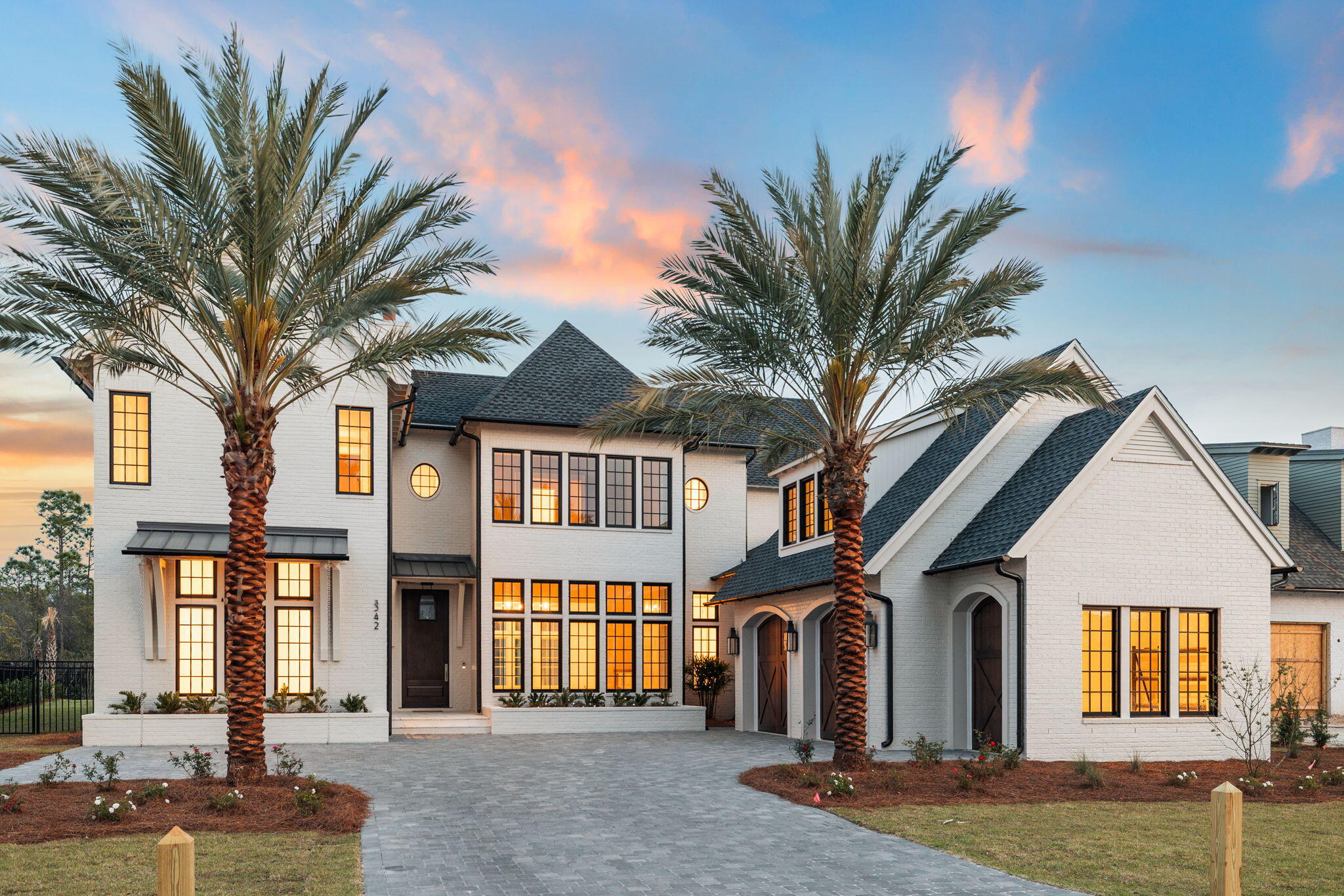 a front view of a house with a garden