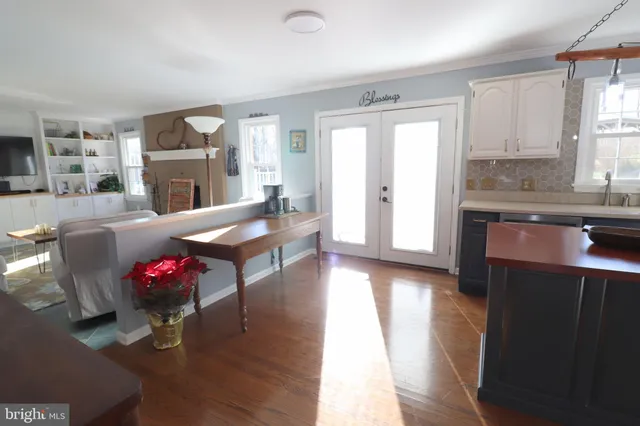 a kitchen with kitchen island a counter top space and stainless steel appliances