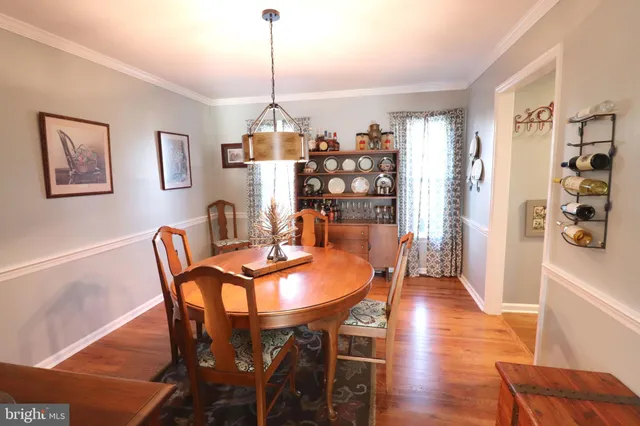 a living room with fireplace furniture and a wooden floor