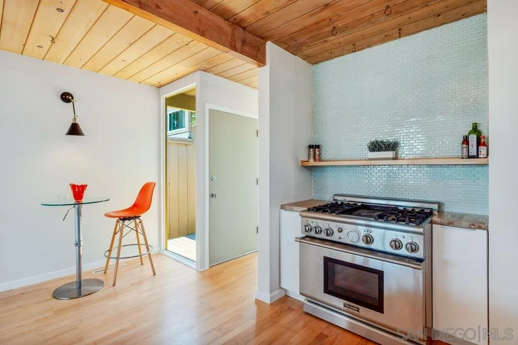 1238 Agate Street San Diego, CA 92109 - Photo 12 of 25 a kitchen with a stove and wooden floor