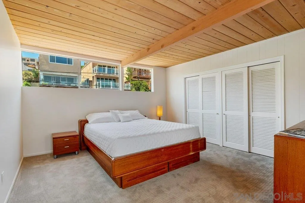 1238 Agate Street San Diego, CA 92109 - Photo 16 of 25 a bed sitting in a spacious bedroom next to a window