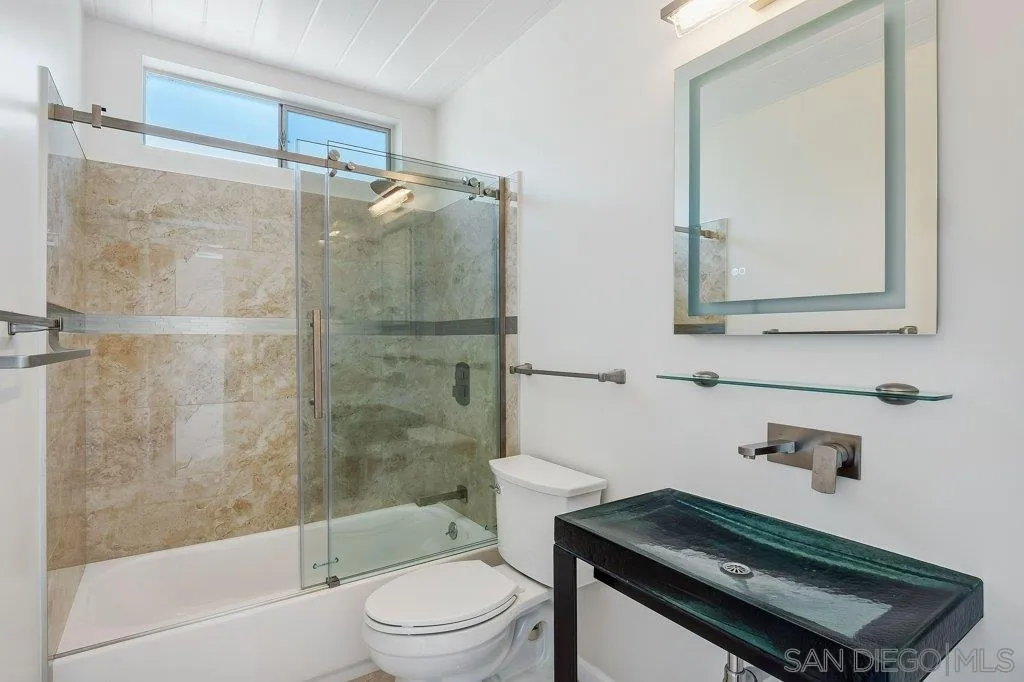 1238 Agate Street San Diego, CA 92109 - Photo 20 of 25 a bathroom with a sink toilet and shower