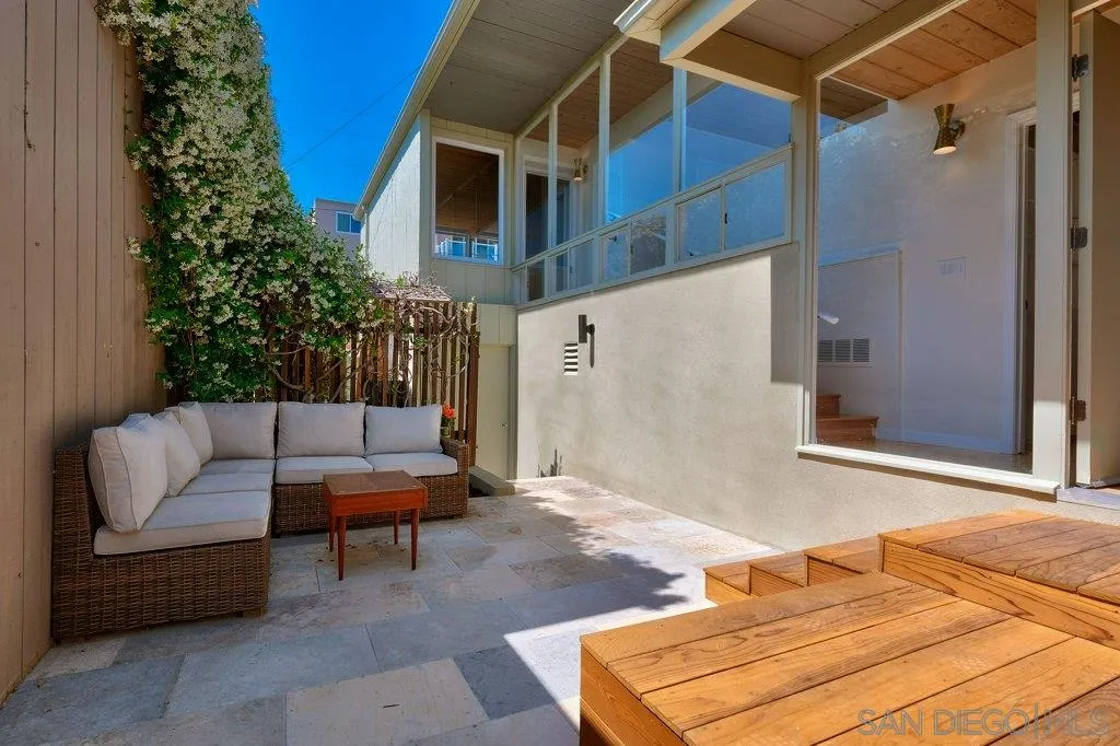 1238 Agate Street San Diego, CA 92109 - Photo 24 of 25 a backyard of a house with sofas fire pit and outdoor seating