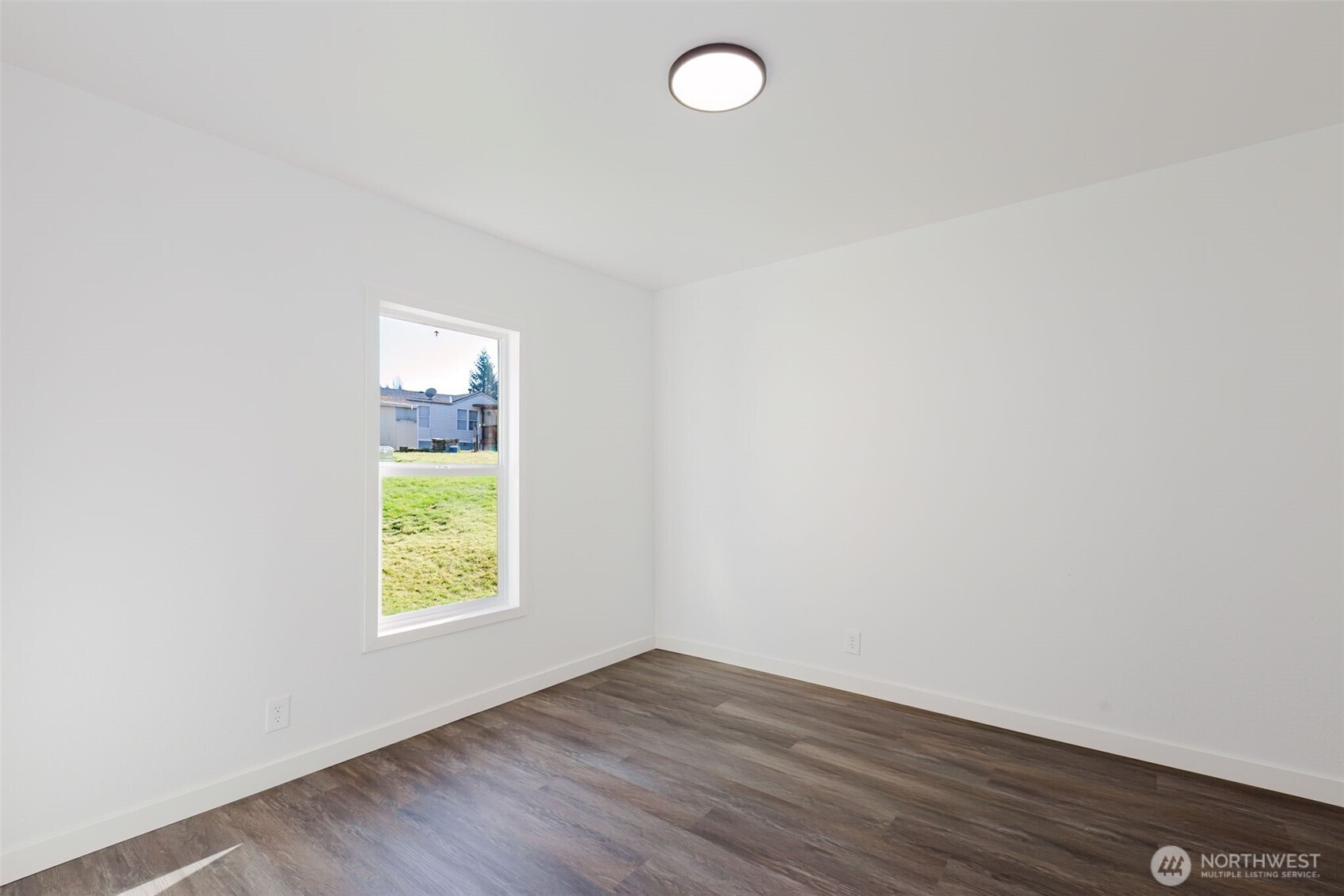 3371 Southeast Bielmeier Road, Unit 78 Port Orchard, WA 98367 - Photo 18 of 27 an empty room with wooden floor and windows