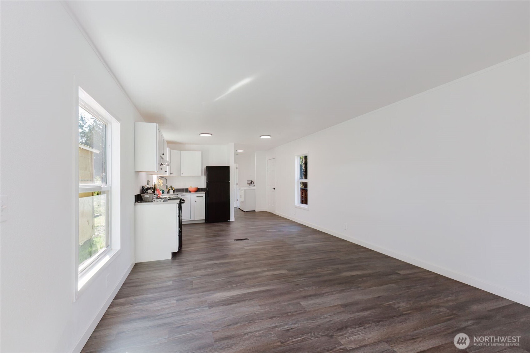 3371 Southeast Bielmeier Road, Unit 78 Port Orchard, WA 98367 - Photo 4 of 27 a view of a kitchen with wooden floor