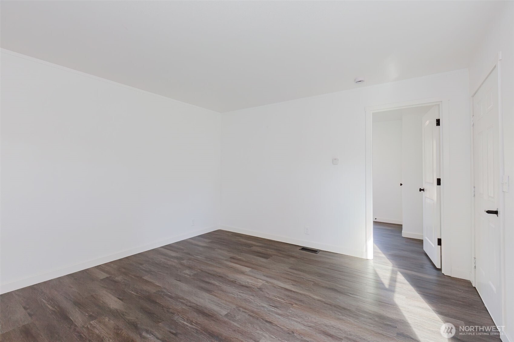 3371 Southeast Bielmeier Road, Unit 78 Port Orchard, WA 98367 - Photo 9 of 27 a view of a room with wooden floor