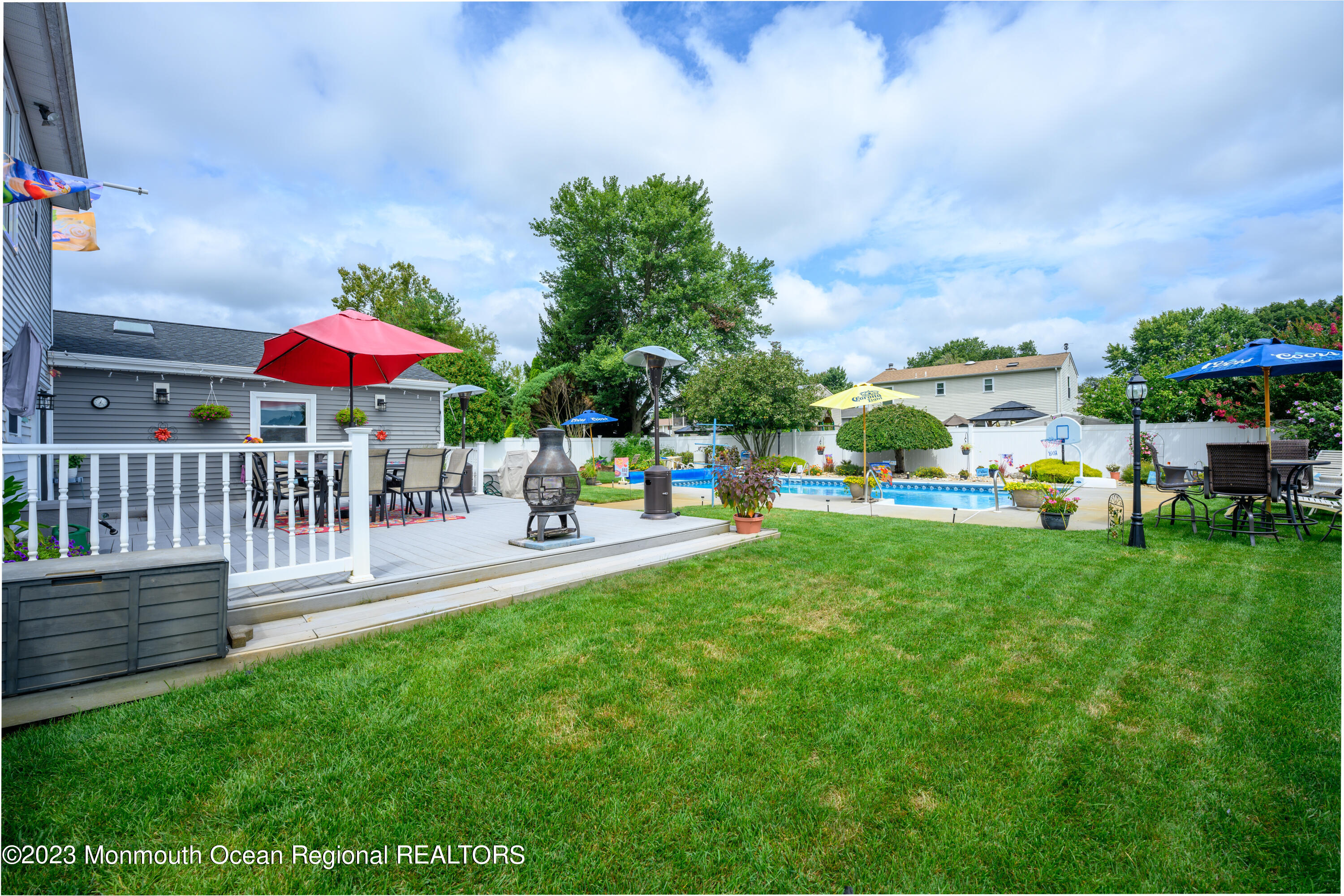 46 Hedgewood Road Howell, NJ 07731 - Photo 38 of 42 a view of a patio with a table and chairs under an umbrella