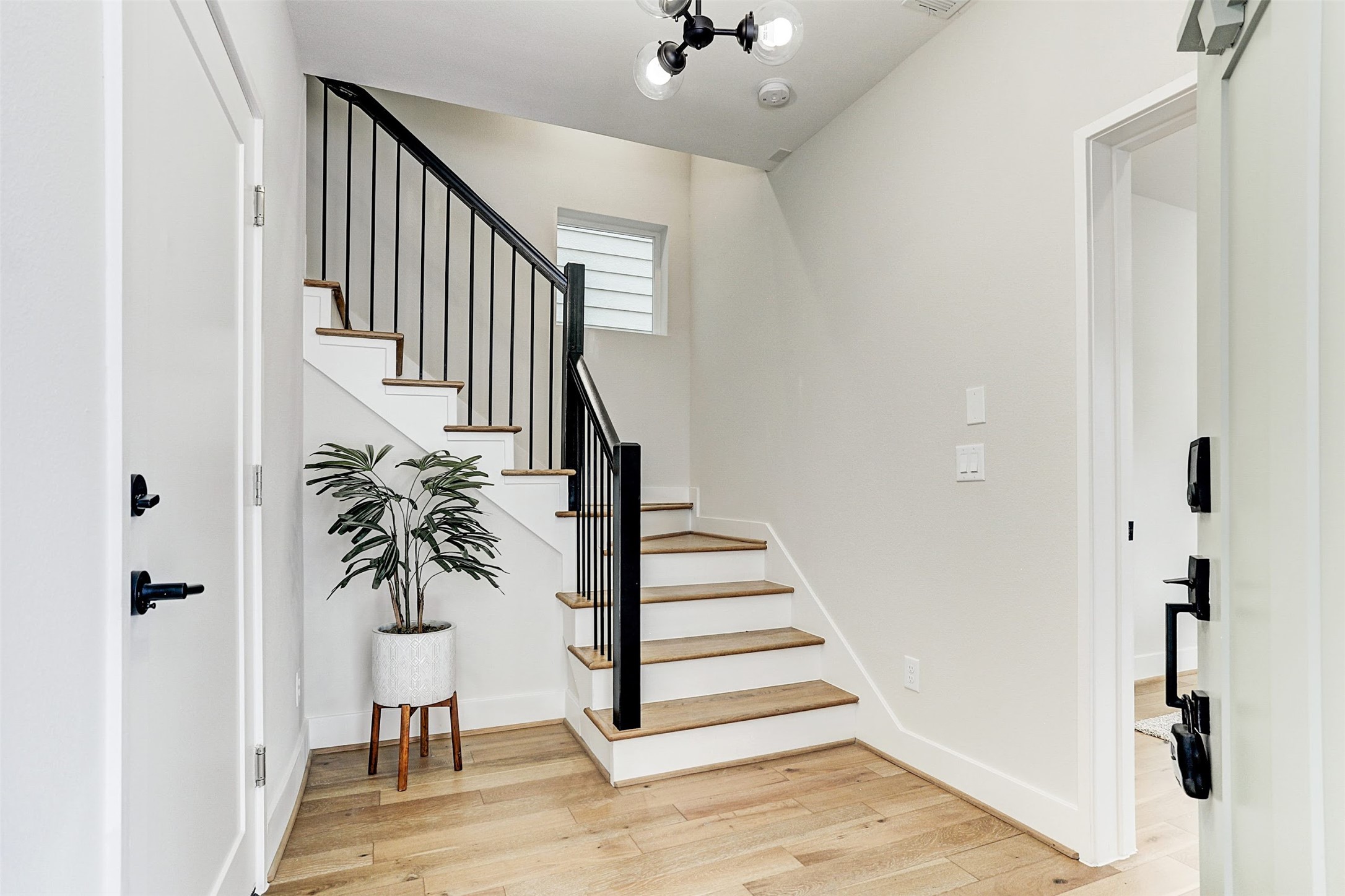 1115 West 15th 1/2 Street, Unit A Houston, TX 77008 - Photo 2 of 20 a view of entryway with wooden floor and stairs