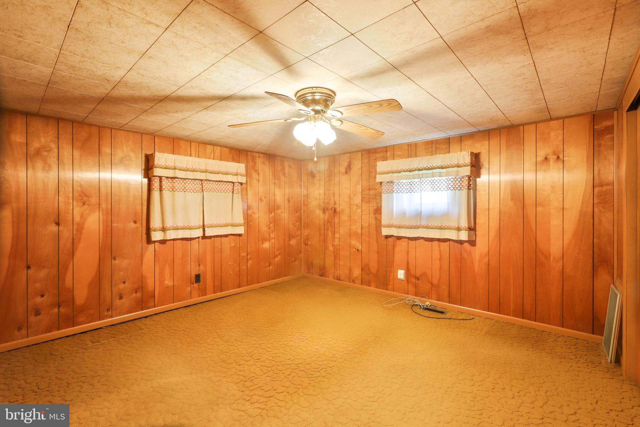 10572 Upper Strasburg Road Upperstrasburg, PA 17265 - Photo 18 of 27 an empty room with windows and fan