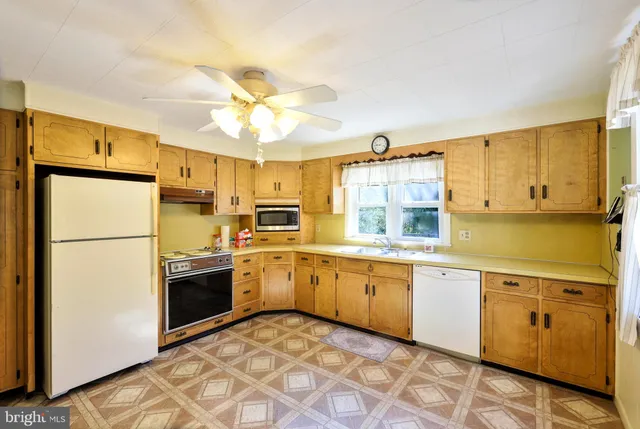 a kitchen with a sink stove and refrigerator