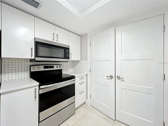 a kitchen with granite countertop a sink and cabinets