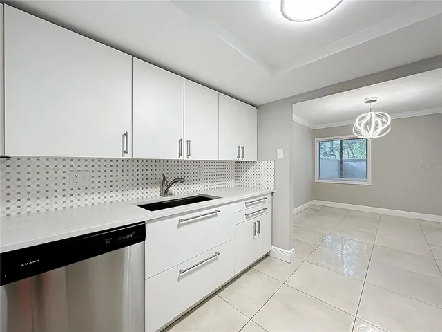 a kitchen with granite countertop a sink and a stove