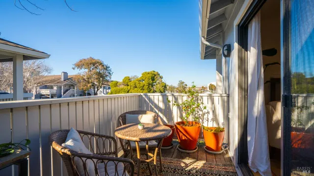 a view of balcony with wooden floor and outdoor seating