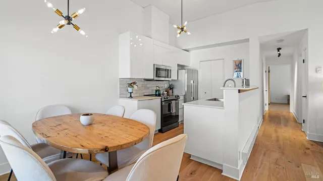 a living room with furniture a flat screen tv and a table