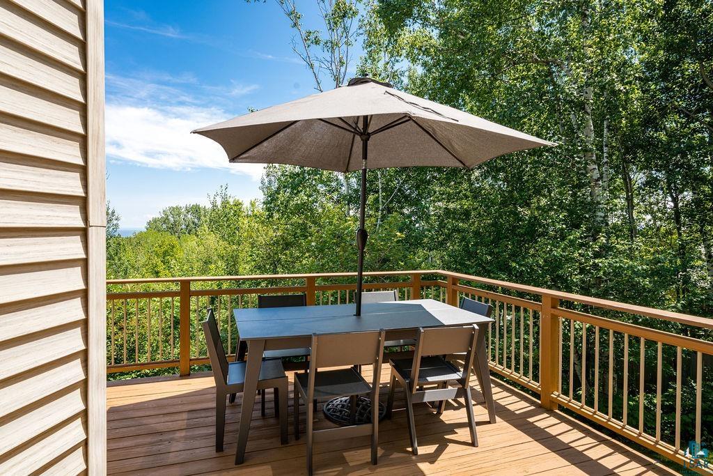 4856 Kingston Street Duluth, MN 55804 - Photo 75 of 88 Expansive outdoor deck featuring wood-finish flooring and sturdy railings, surrounded by mature trees