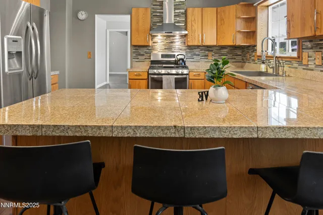 a kitchen with a table chairs and a sink