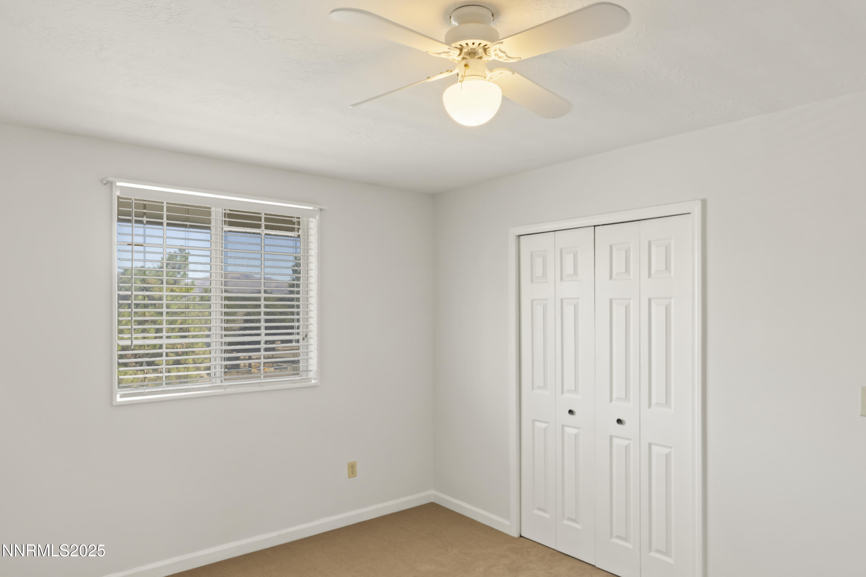 1165 Farm Lane Fernley, NV 89408 - Photo 18 of 38 an empty room with windows and fan