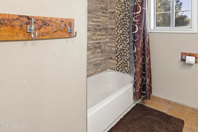 a bathroom with a bathtub and shower