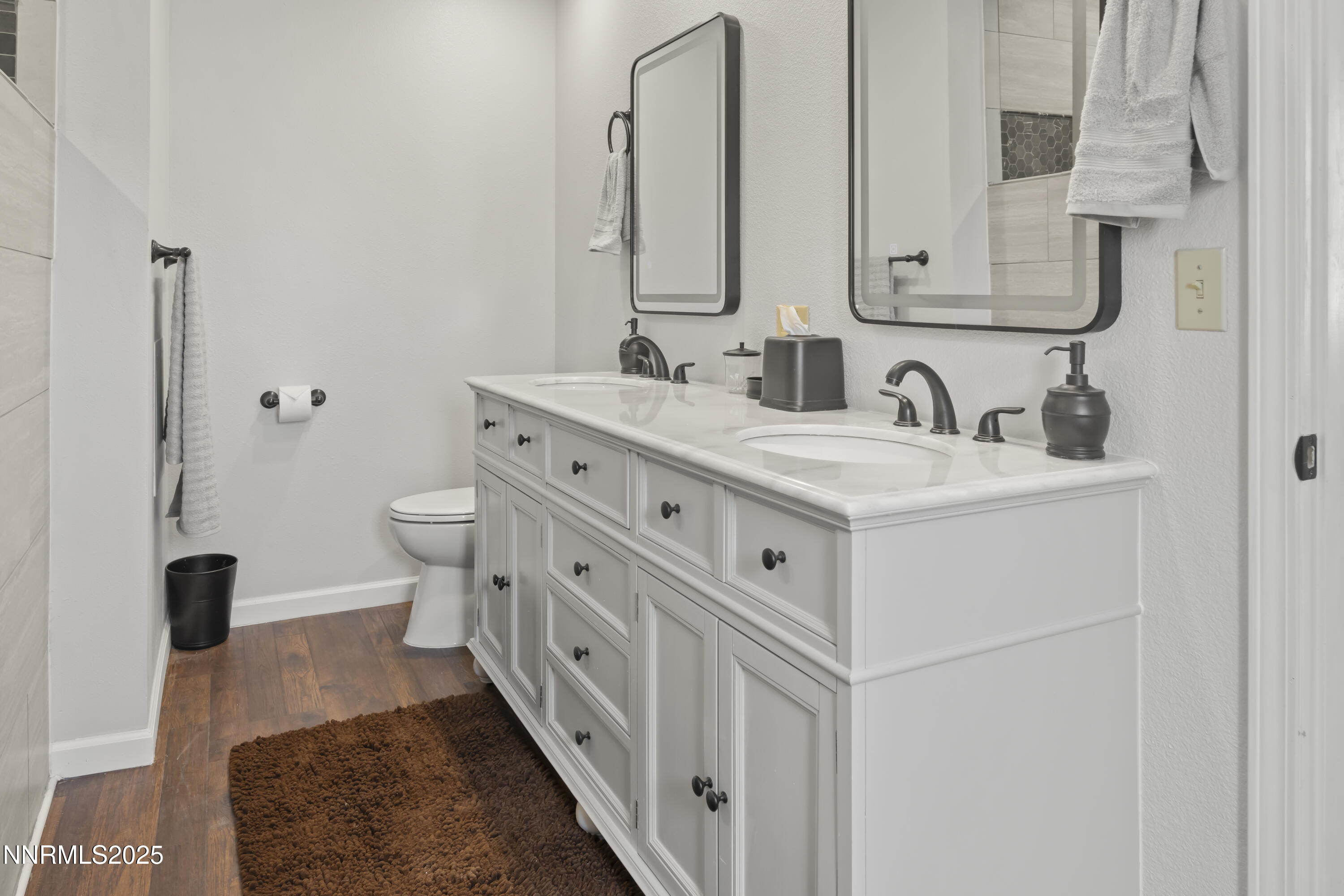 1165 Farm Lane Fernley, NV 89408 - Photo 26 of 38 a bathroom with a double vanity sink mirror and toilet