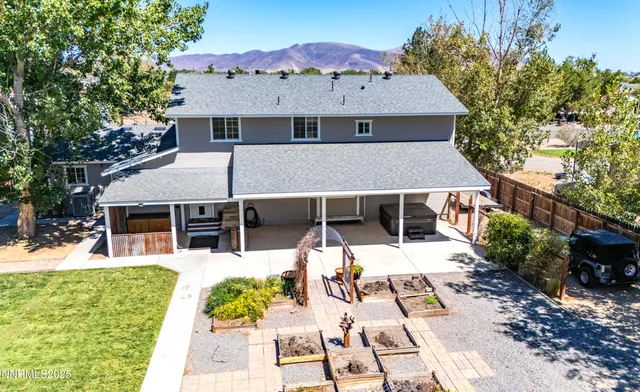an aerial view of a house with swimming pool and porch